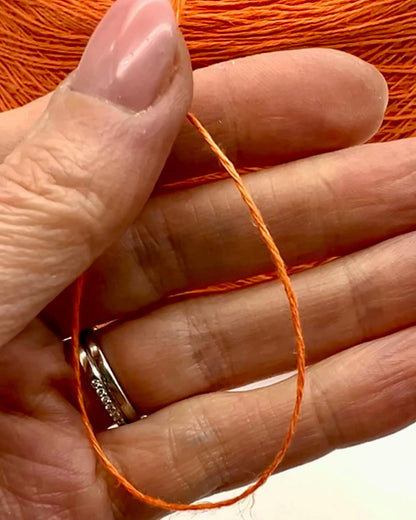 Premium iDOKNiT fingering weight yarn, FRESCOLINO by RiGo Italy. 100% pure linen fiber with an Nm 3/12 count, providing 400m per 100g. Authentic Italian-made plant fiber curated by iDOKNiT for breathable, long-lasting summer garments in vibrant shades like 1488 Orange and 1489 Beige.