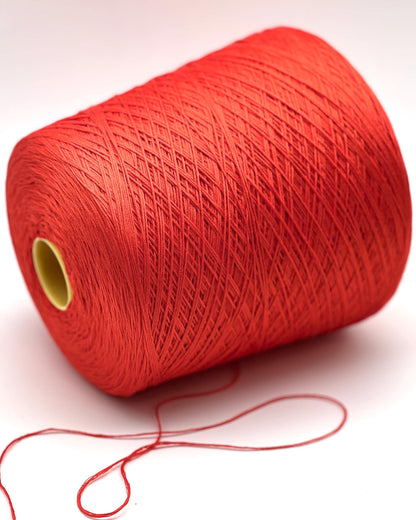 Luxury COTTON SILK lace-weight yarn by Botto Giuseppe, Italy – 55% silk and 45% cotton blend, super soft with an elegant natural sheen. Shown in vibrant coral red on a cone. Ideal for summer tops, lightweight layering, and luxury blending. Premium Italian yarn available at iDOKNiT.com.