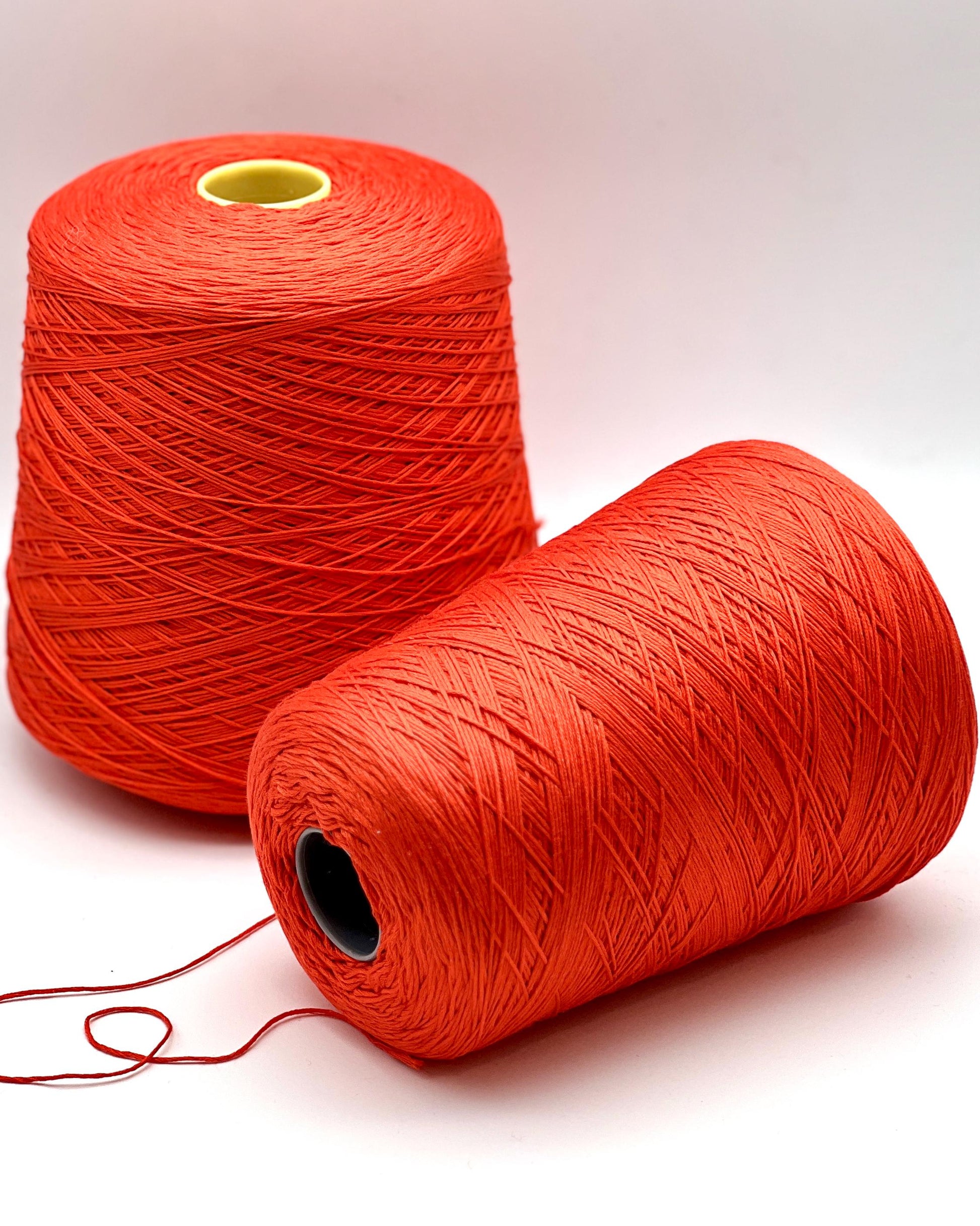 Luxury COTTON SILK lace-weight yarn by Botto Giuseppe, Italy – 55% silk and 45% cotton blend, super soft with an elegant natural sheen. Shown in vibrant coral red on a cone. Ideal for summer tops, lightweight layering, and luxury blending. Premium Italian yarn available at iDOKNiT.com.