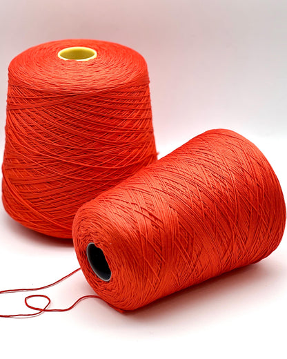 Luxury COTTON SILK lace-weight yarn by Botto Giuseppe, Italy – 55% silk and 45% cotton blend, super soft with an elegant natural sheen. Shown in vibrant coral red on a cone. Ideal for summer tops, lightweight layering, and luxury blending. Premium Italian yarn available at iDOKNiT.com.
