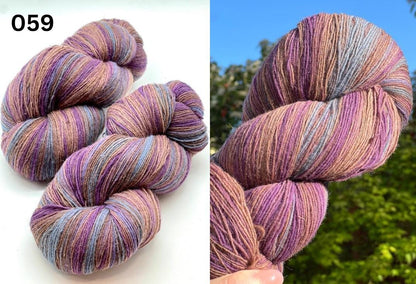 Small-batch dyed heritage skeins of 100% Latvian Dark-Headed Sheep Wool in earthy multicolor gradients like Green-Brown #052. The image shows the rustic single-ply texture and the sheep breed origin, representing the authentic wool traditions of Paces Vilnas Fabrika, Latvia. Available at iDOKNiT.com.