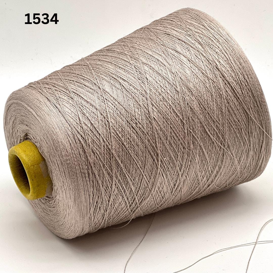 Emilcotoni Silk & Cotton lace yarn from Italy. Shown on professional cones in shades like Ochre, Navy Blue, and Brown. High-quality designer yarn for retail at iDOKNiT.com.