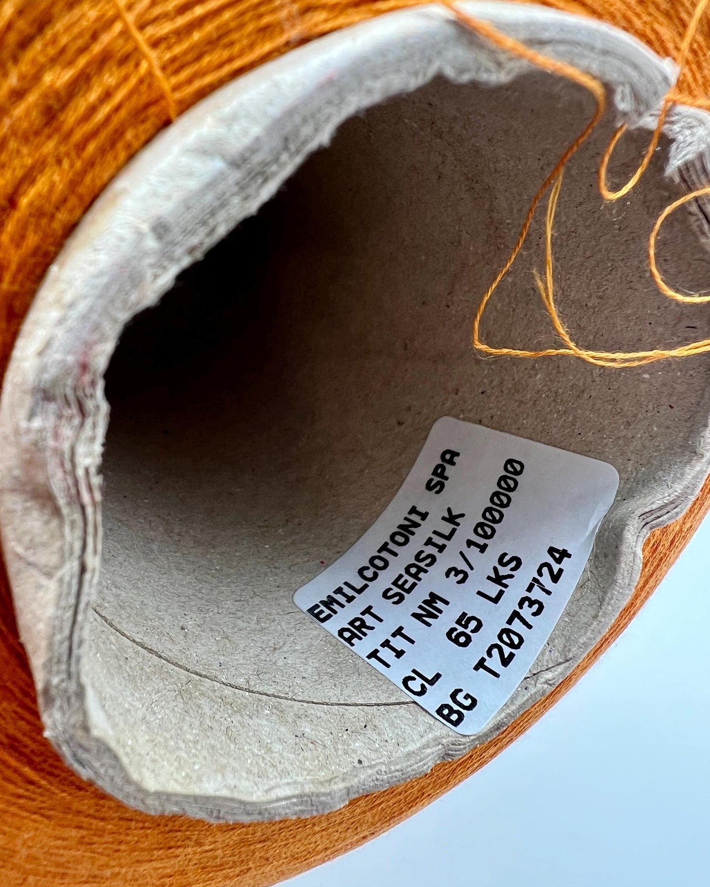 Emilcotoni Silk & Cotton lace yarn from Italy. Shown on professional cones in shades like Ochre, Navy Blue, and Brown. High-quality designer yarn for retail at iDOKNiT.com.