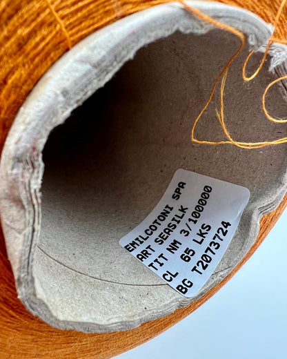 Emilcotoni Silk & Cotton lace yarn from Italy. Shown on professional cones in shades like Ochre, Navy Blue, and Brown. High-quality designer yarn for retail at iDOKNiT.com.