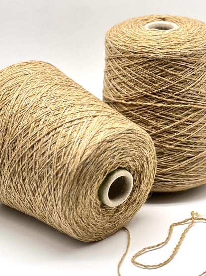 Two spools of beige thread on a white background