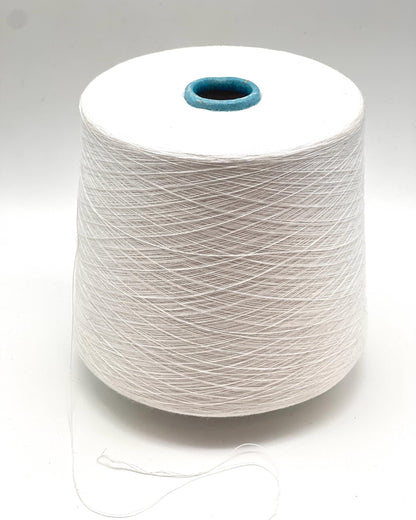 Spool of white yarn on a gray background