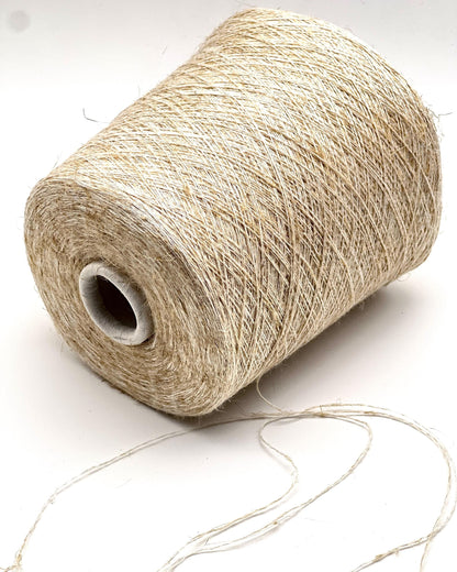 Spool of beige thread on a white background