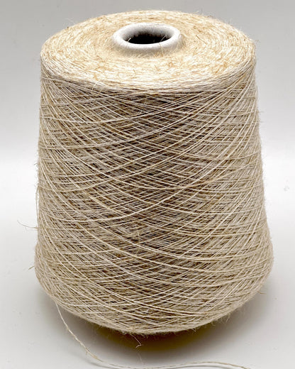 Spool of beige thread on a white background