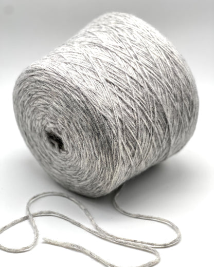 Roll of gray yarn on a white background