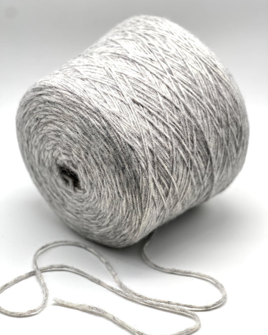 Roll of gray yarn on a white background