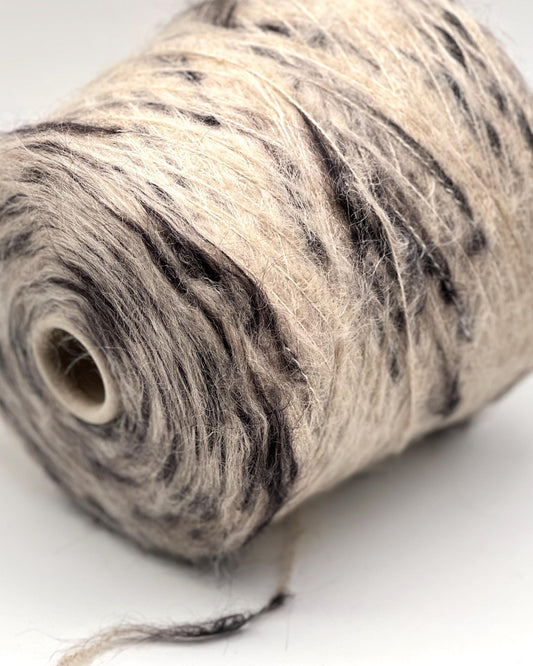 Spool of natural fiber yarn on a white background