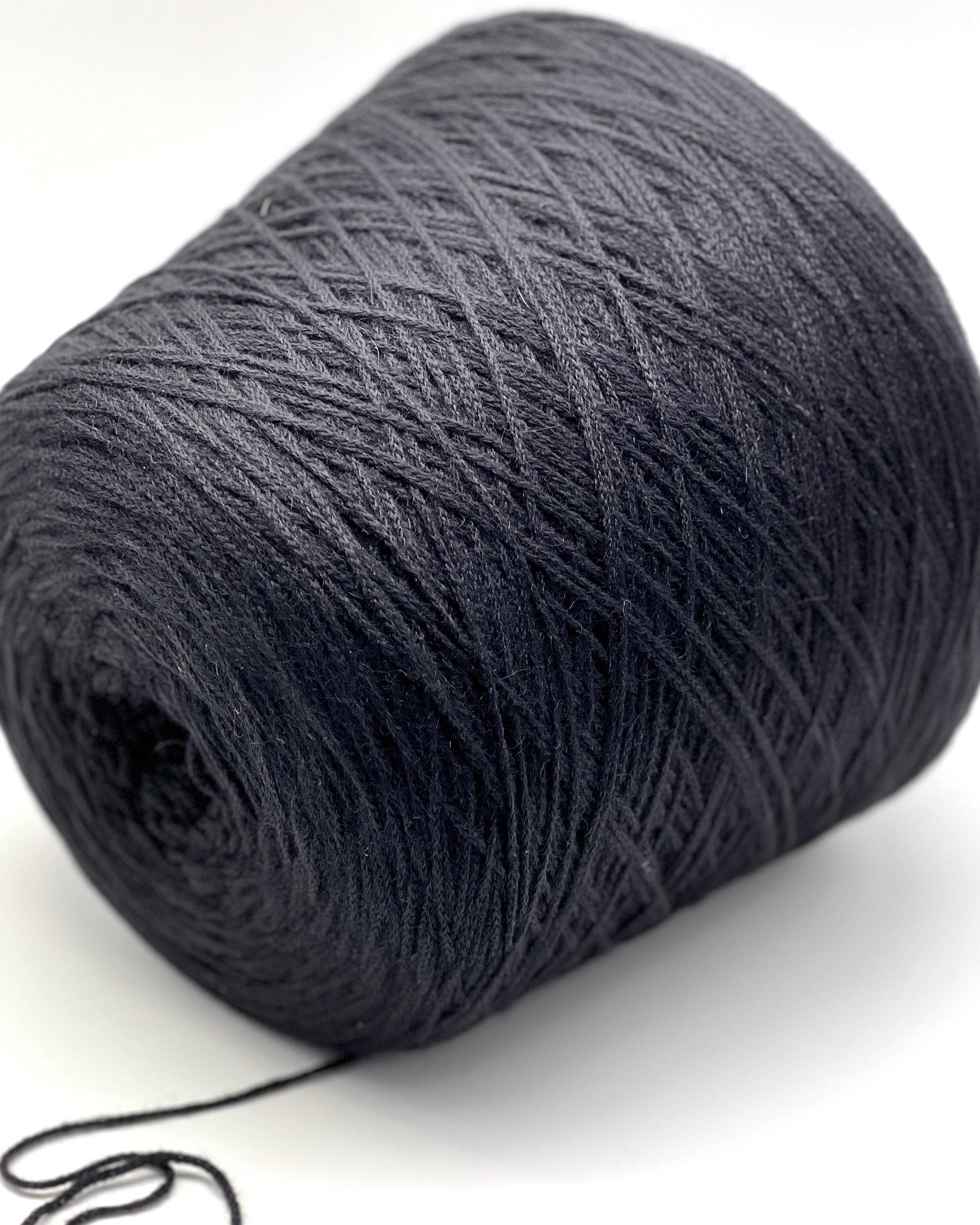 Large ball of dark gray yarn on a white background