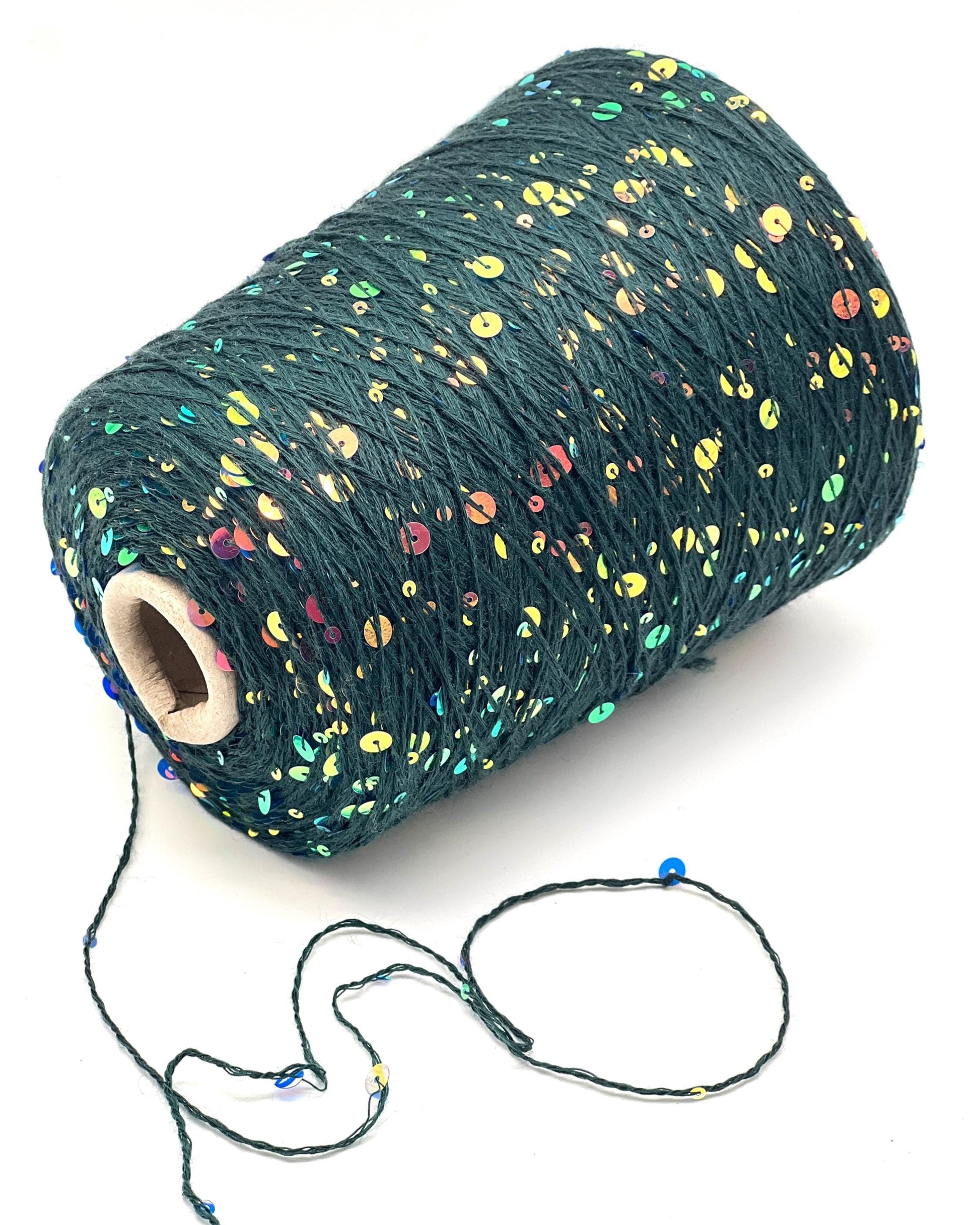 Spool of dark green yarn with multicolored speckles on a white background