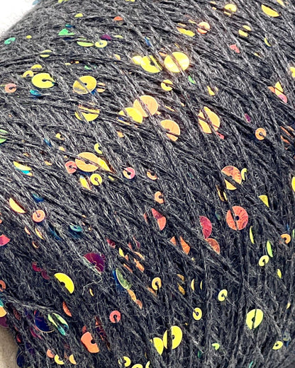 Close-up of dark yarn with colorful speckles