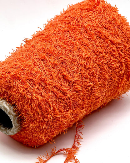 Close-up of an orange scrubber on a white background