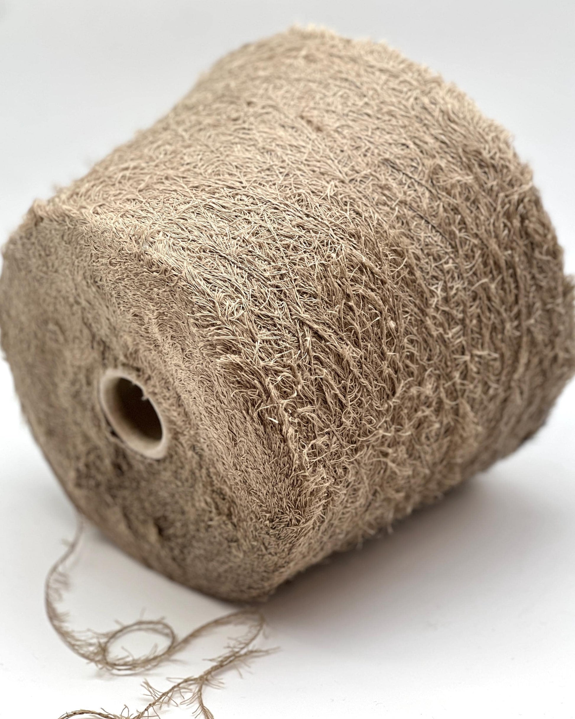Roll of brown twine on a white background