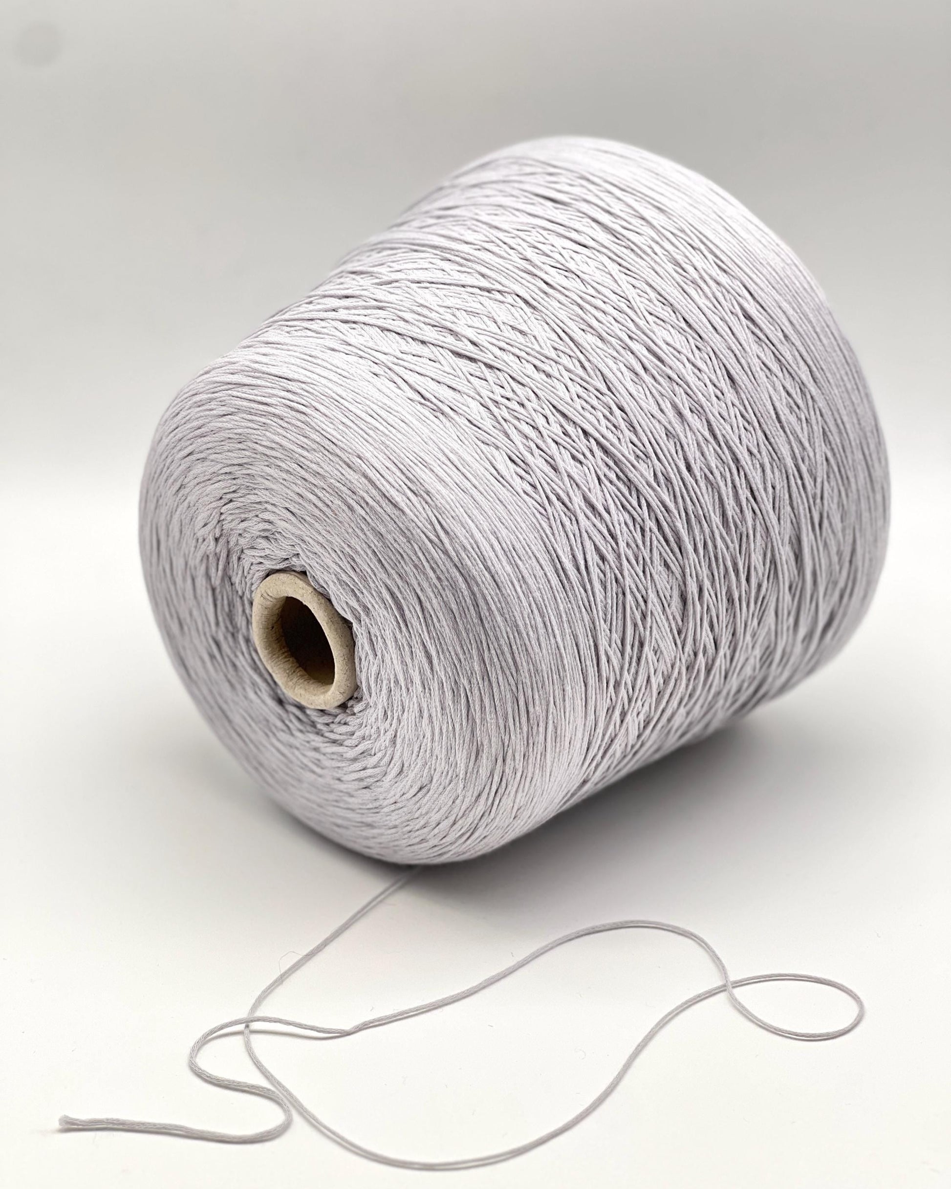 Spool of gray yarn on a white background