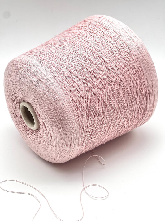Pink yarn spool on a white background