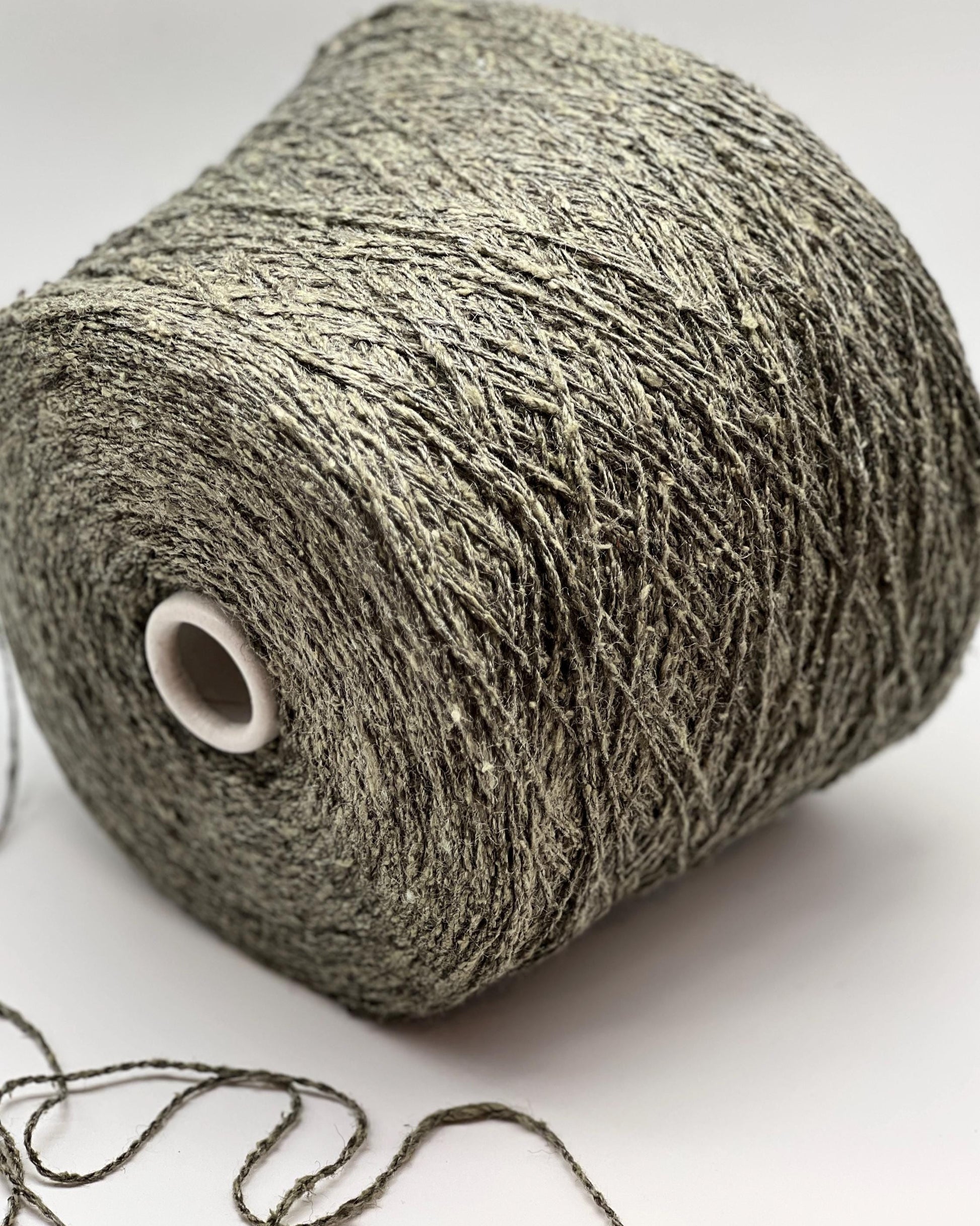 Roll of gray yarn on a white background