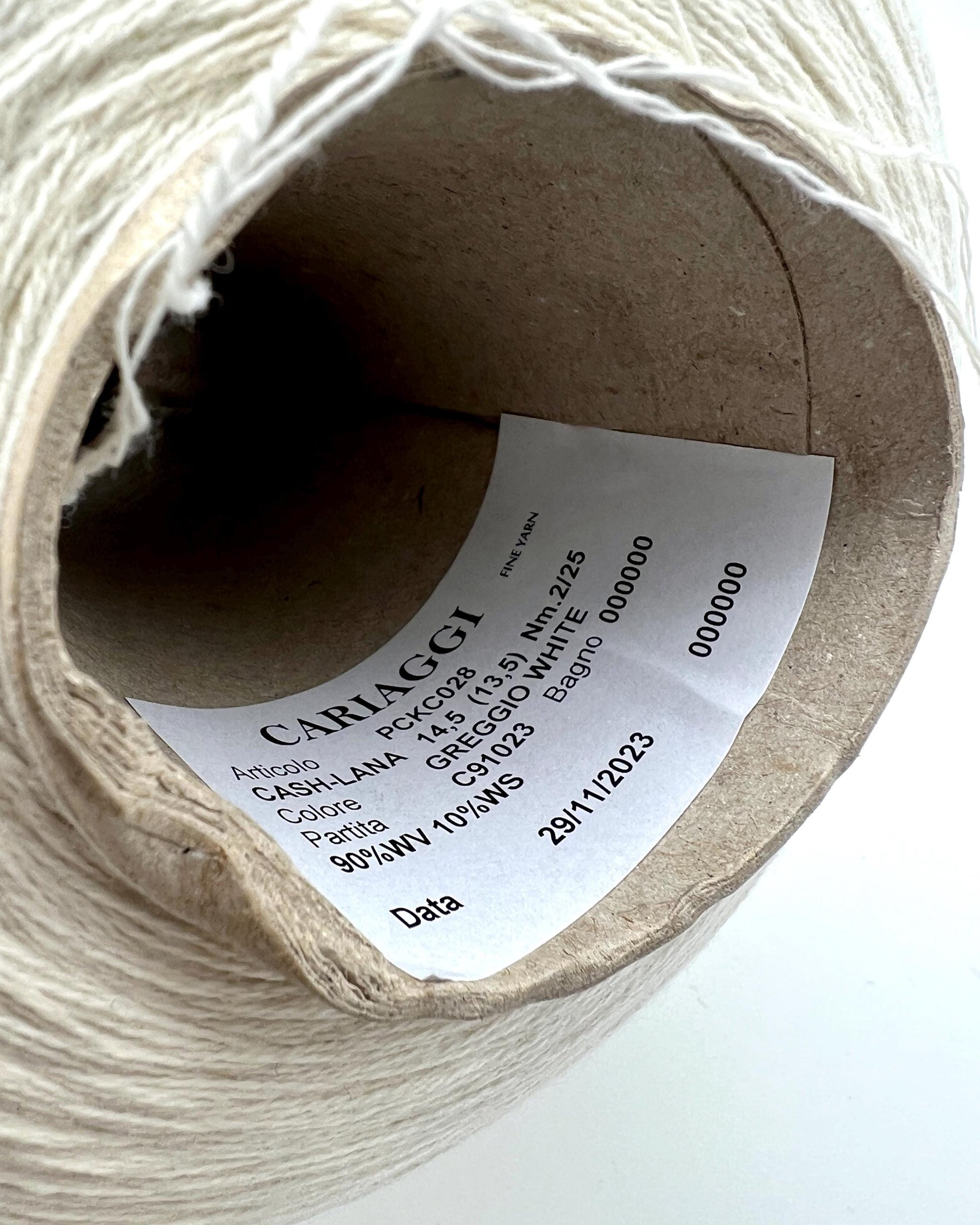 Spool of yarn with a label on a white background