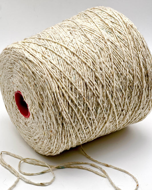 Spool of beige thread on a white background