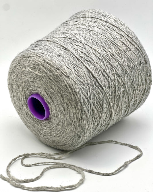 Spool of gray yarn with a purple core on a white background
