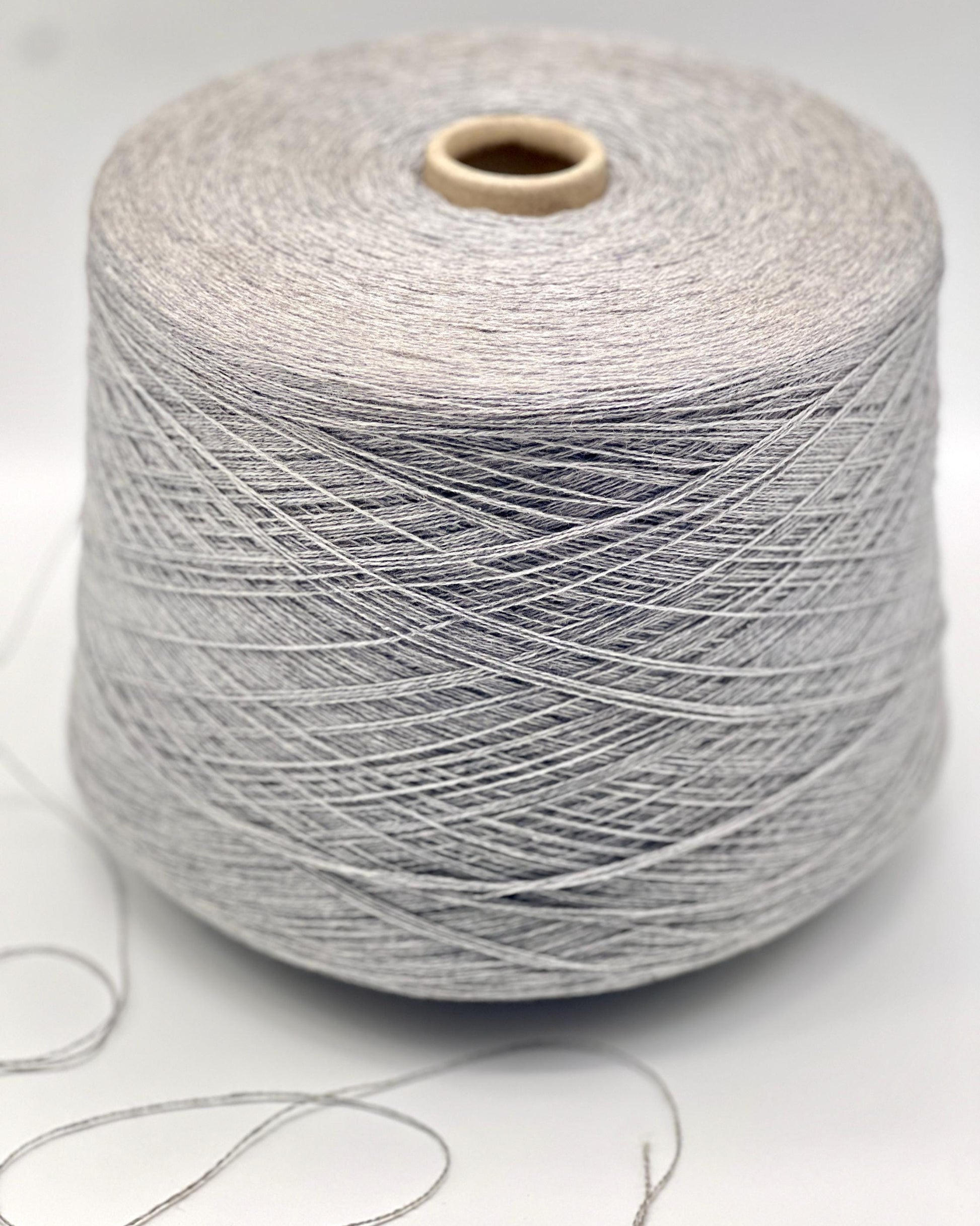 Spool of gray yarn on a white background