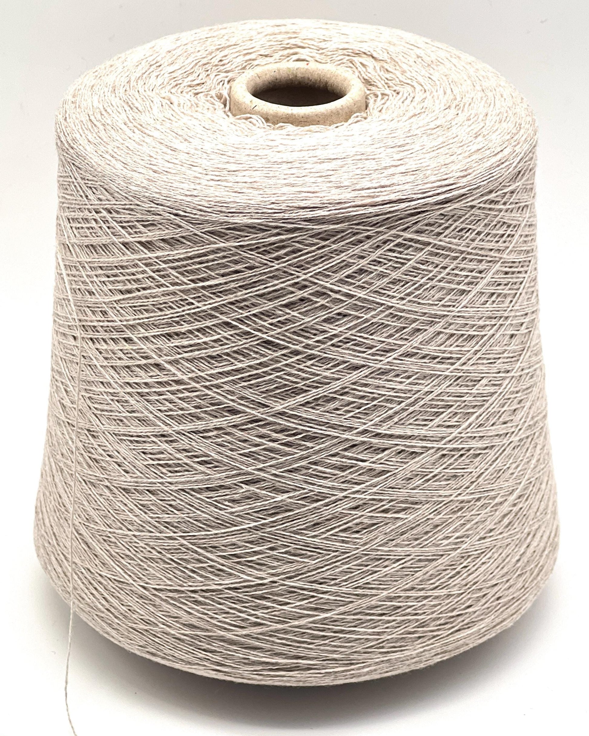 Spool of beige thread on a white background