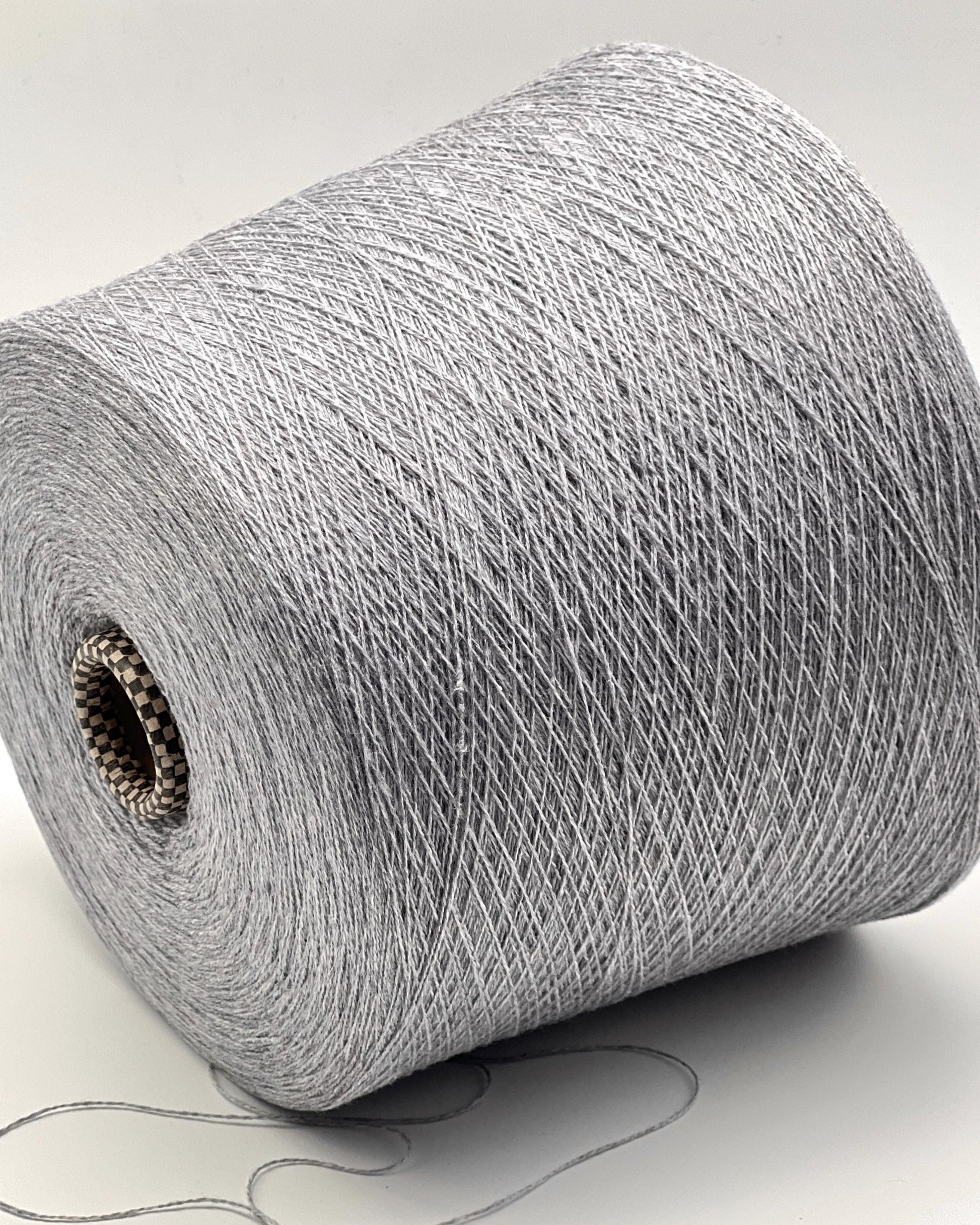 Roll of gray yarn on a white background