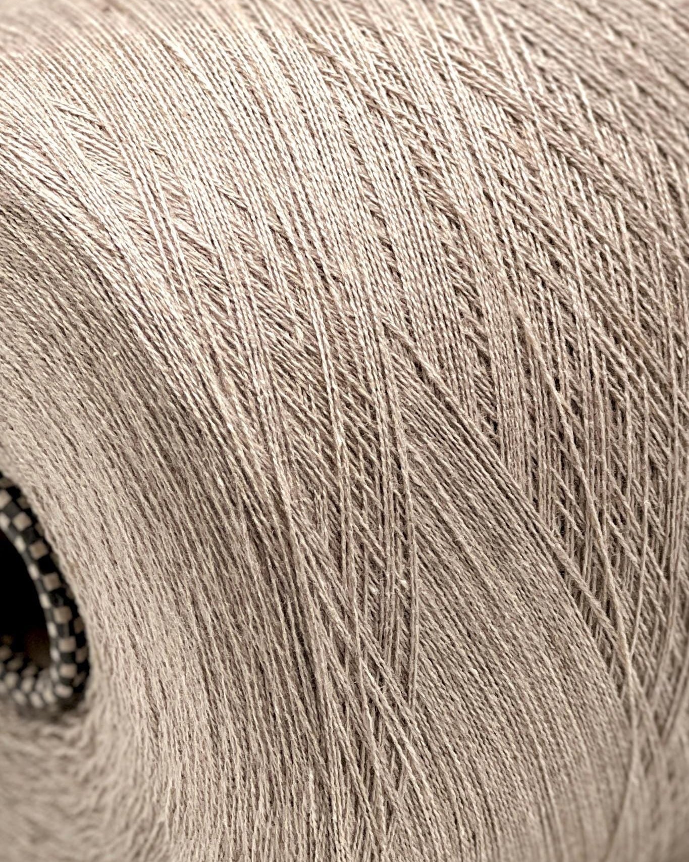 Close-up of a spool of beige yarn