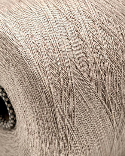 Close-up of a spool of beige yarn