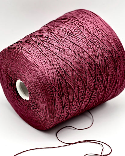 Spool of red yarn on a white background