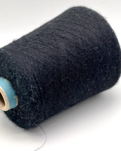 Spool of dark blue thread on a white background