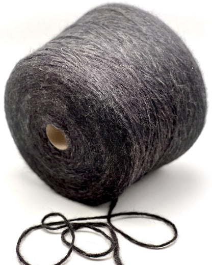 Spool of gray yarn on a white background