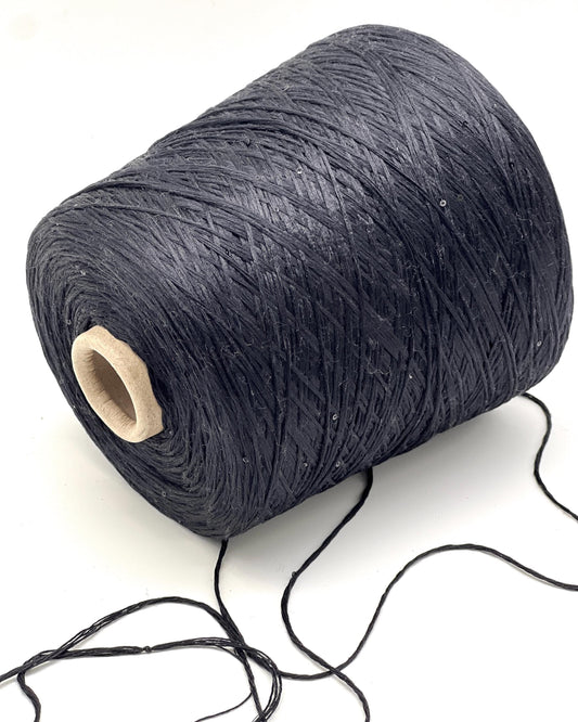 Spool of dark gray yarn on a white background