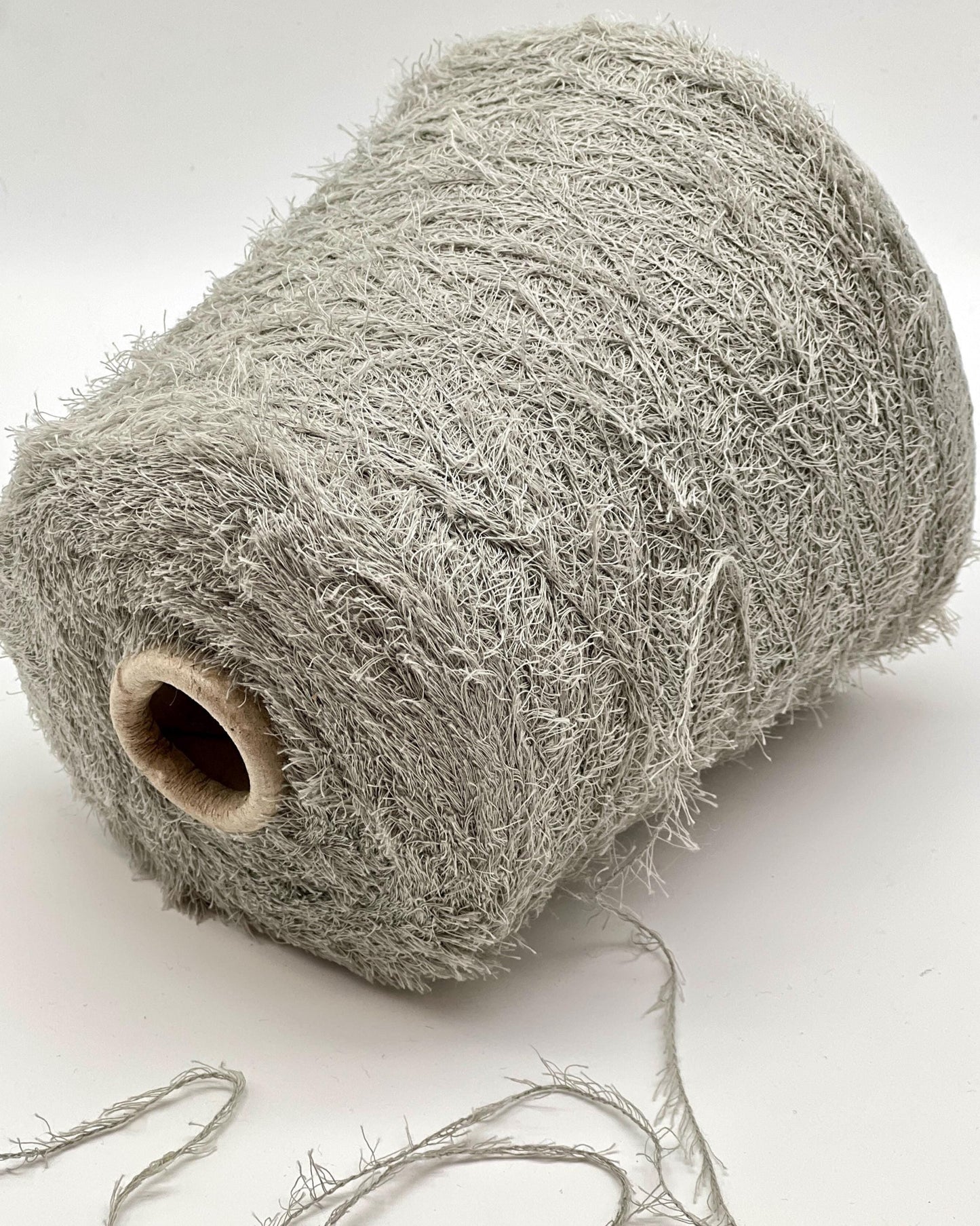 Roll of gray string or twine on a white background