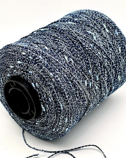 Spool of black and gray yarn on a white background