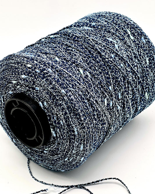 Spool of black and gray yarn on a white background