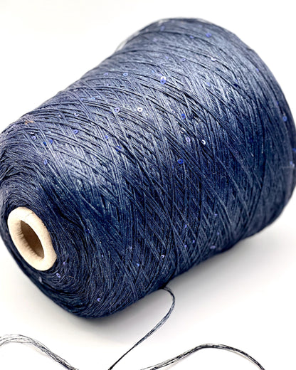 Spool of dark blue thread on a white background