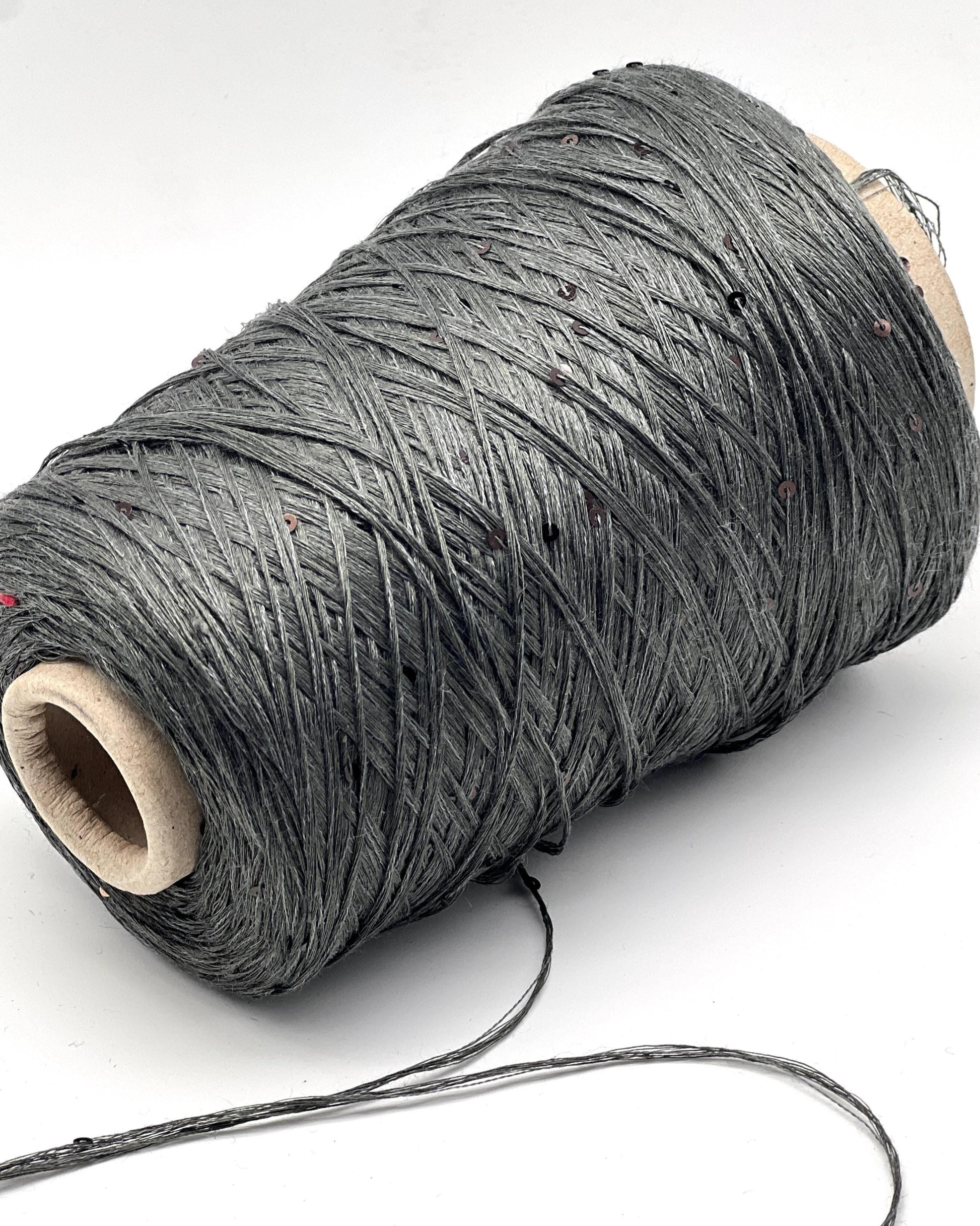 Spool of gray thread on a white background