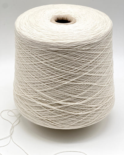 Spool of white yarn on a light gray background