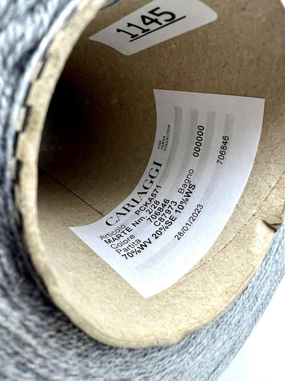 Close-up of a roll of fabric with a label on a cardboard tube