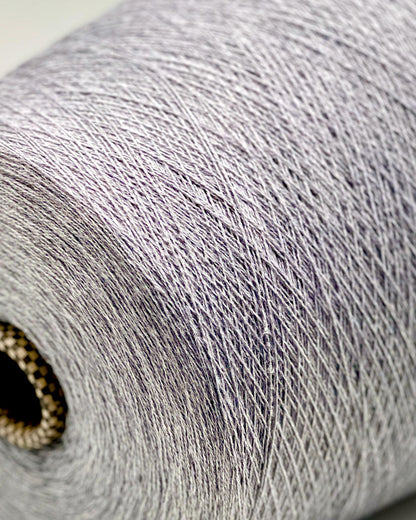 Close-up of a roll of gray yarn with a visible brand logo.