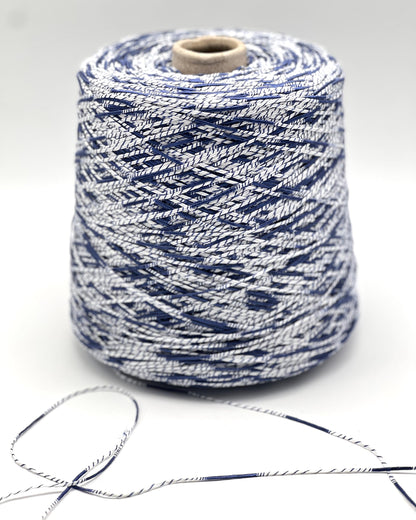 Spool of blue and white yarn on a light gray background