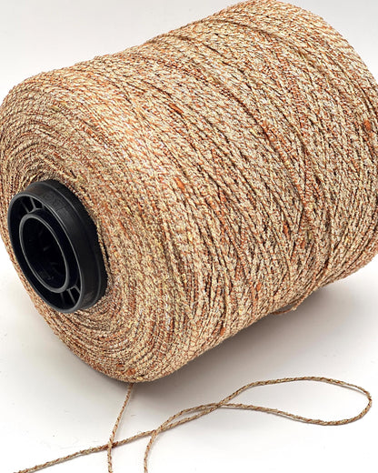 Spool of beige thread on a white background