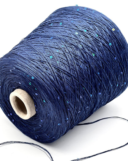 Spool of blue yarn with a wooden core on a white background