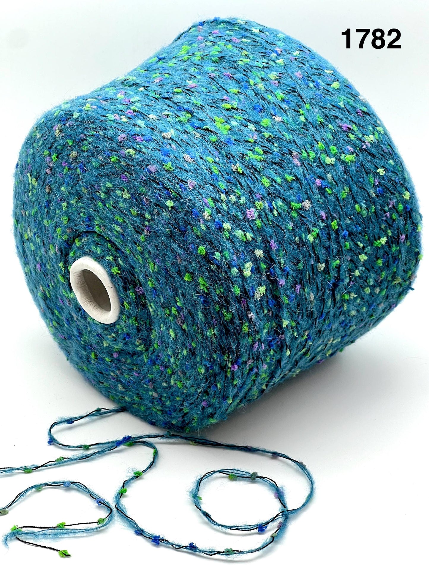 COLOR 1782 AQUA MULTI - Spool of blue yarn with speckles on a white background