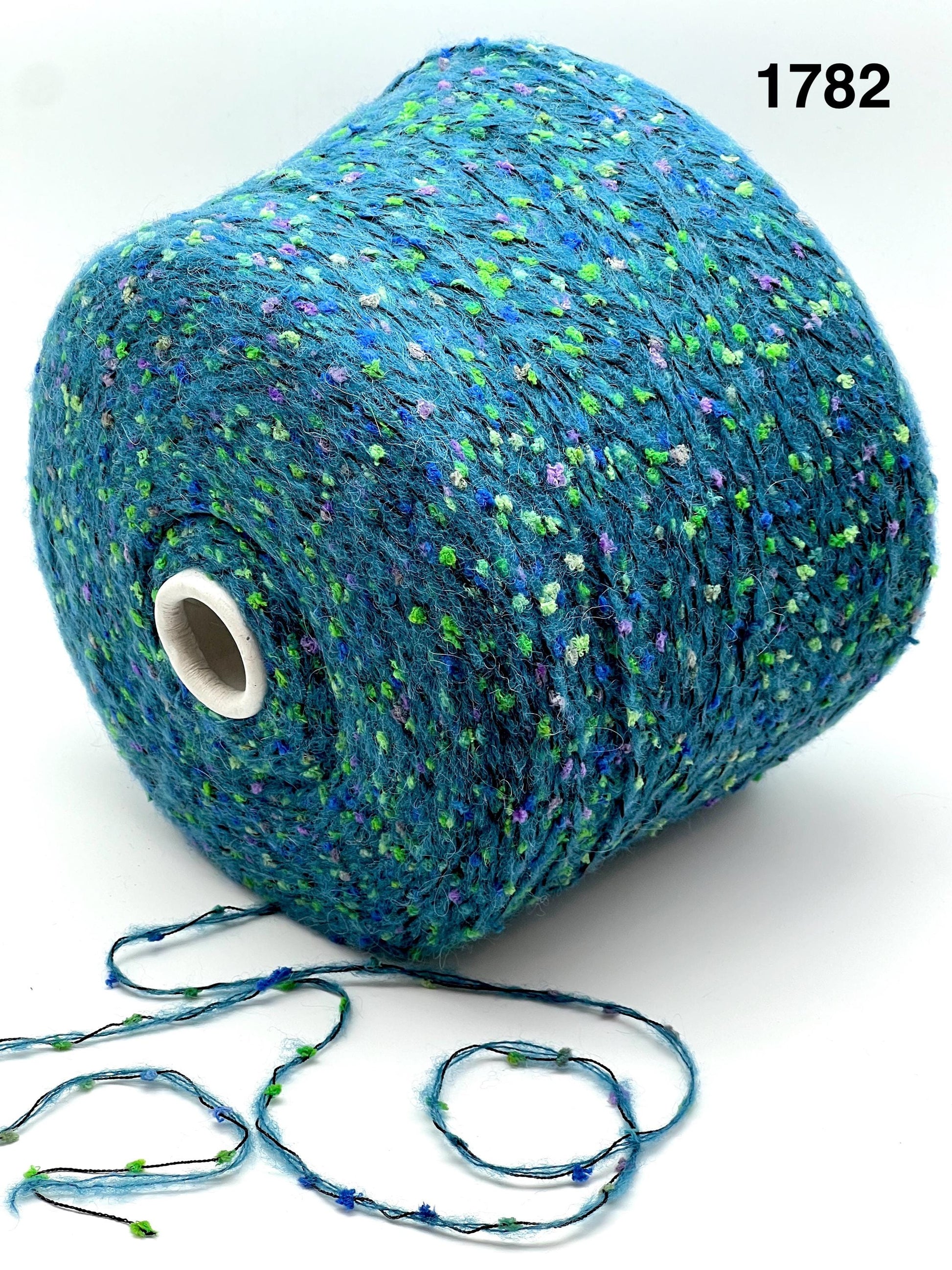 COLOR 1782 AQUA MULTI - Spool of blue yarn with speckles on a white background