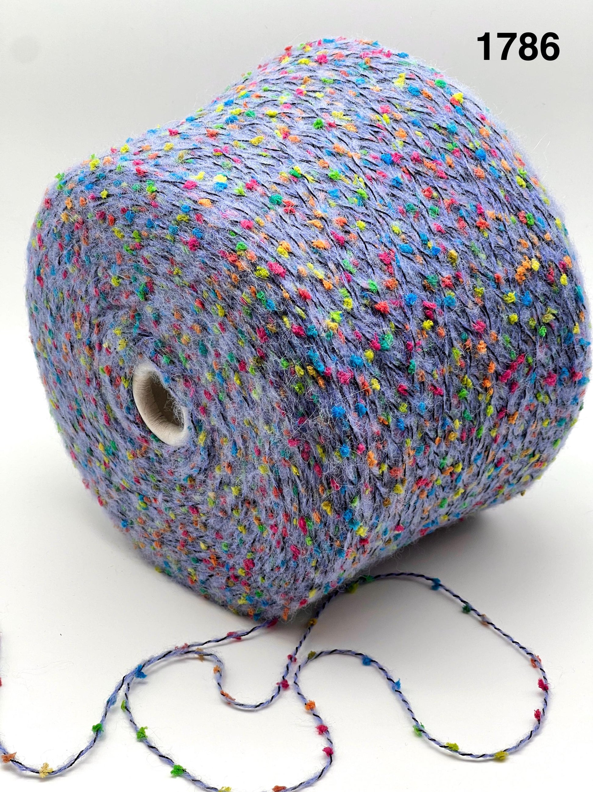 COLOR 1786 VIOLET MULTI - Spool of multicolored yarn on a white background