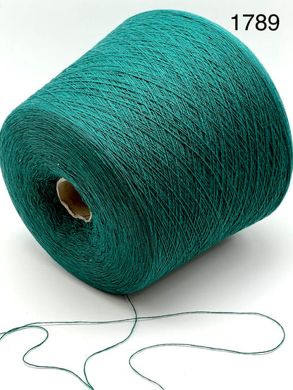 Teal spool of yarn with a small amount of yarn extending on a white background